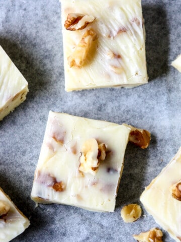 Maple walnut fudge pieces on parchment paper.